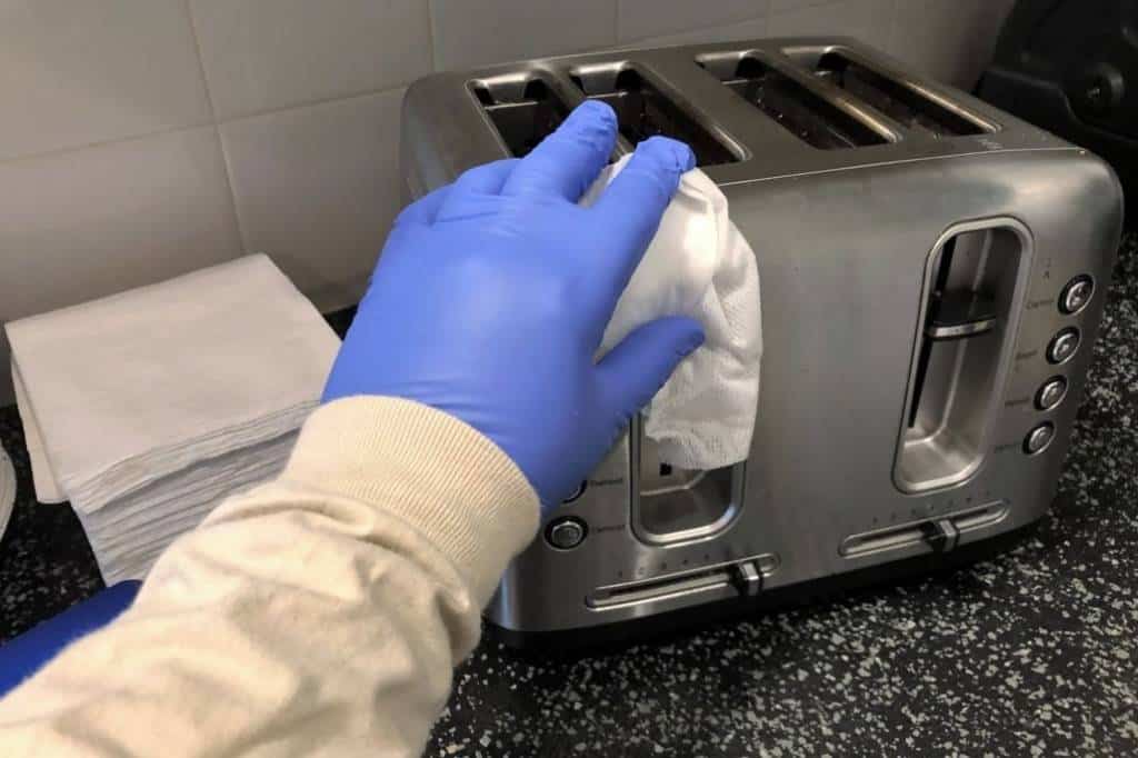 Person Cleaning a Toaster