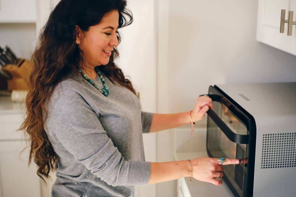 Woman Using a Convection Toaster Oven