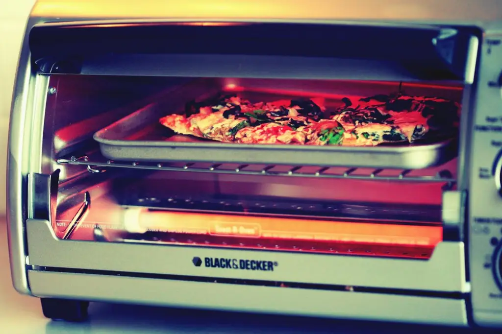 Reheating pizza slices in a Black n Decker toaster oven.