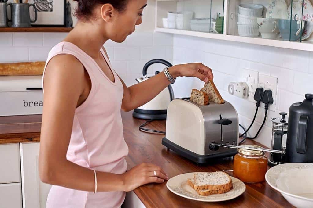 African American Woman Using a Toaster