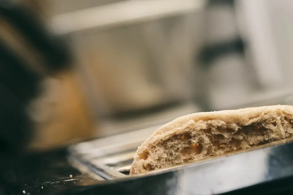 Closeup of English muffin in a toaster.