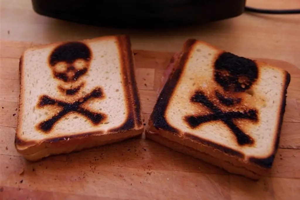 Toasted bread slices with caution sign toasted on them.