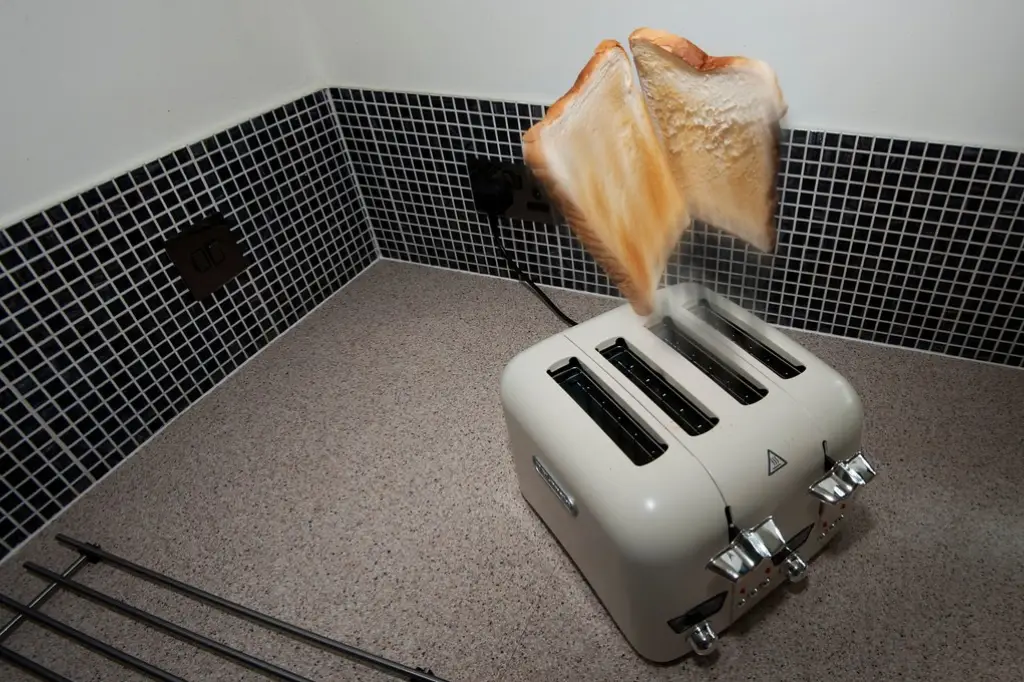 Two slices of bread popping out of a toaster.