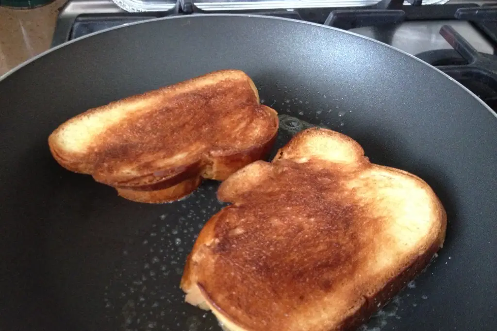 Toasting bread on a stove, in a pan.